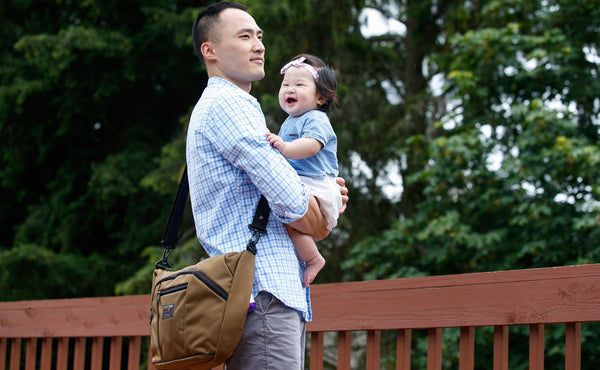 A person carrying a Parental Unit cross-body.